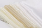 a close-up view of a collection of fabric swatches, with a focus on the color variations between the swatches.