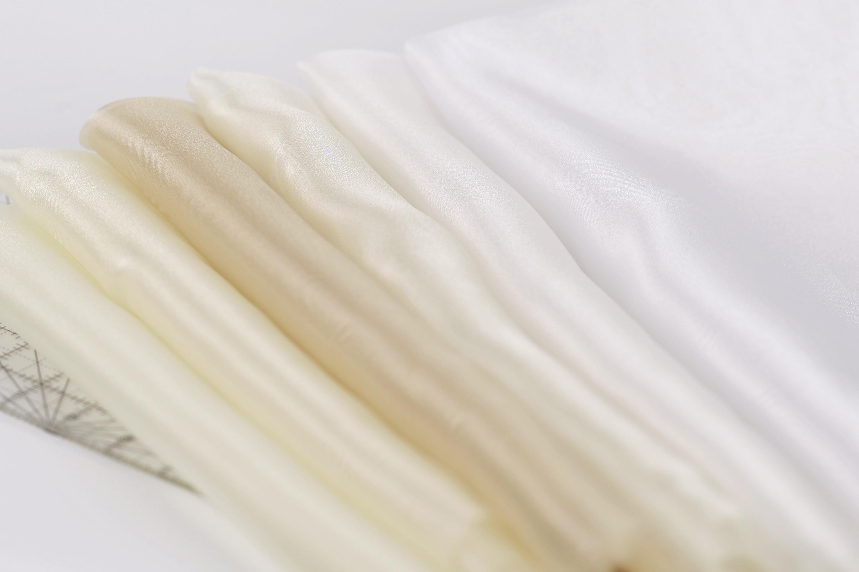 a close-up view of a collection of fabric swatches, with a focus on the color variations between the swatches.