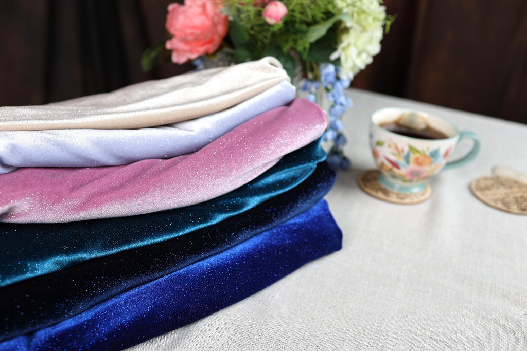 a stack of folded towels next to a cup of coffee