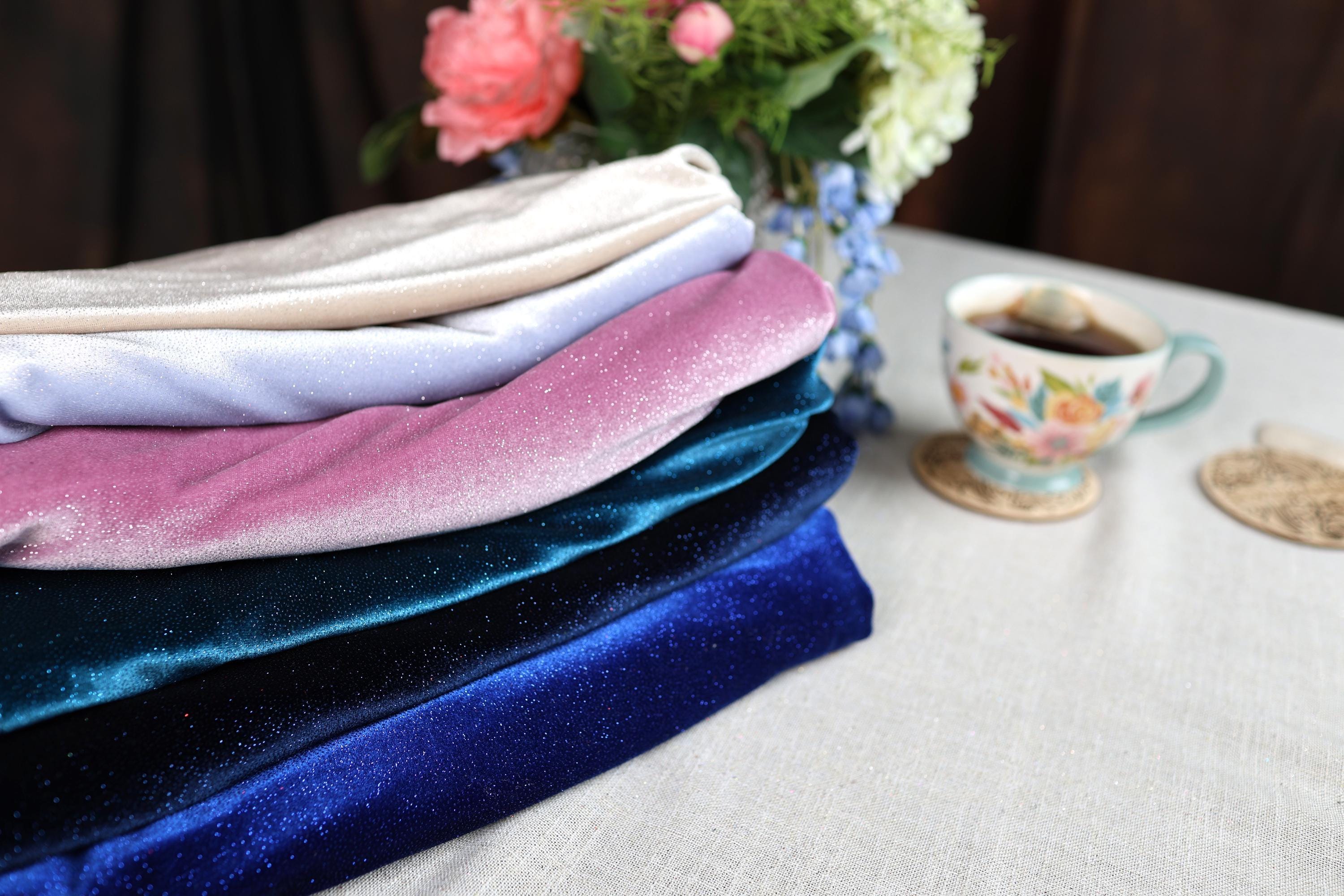 a stack of folded towels next to a cup of coffee