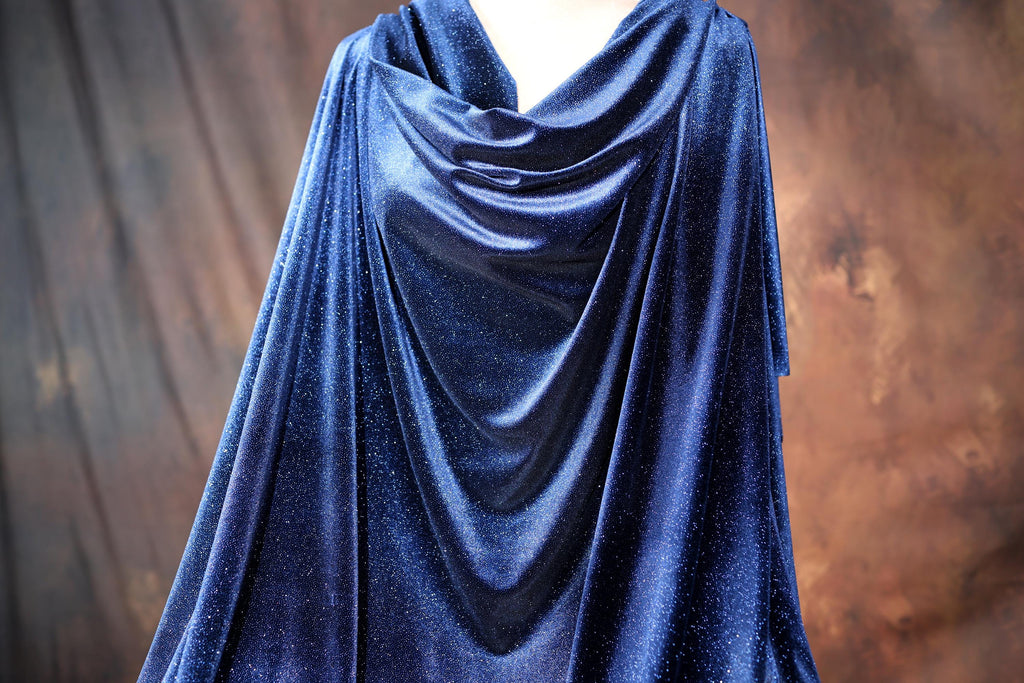 a mannequin dressed in a blue velvet dress