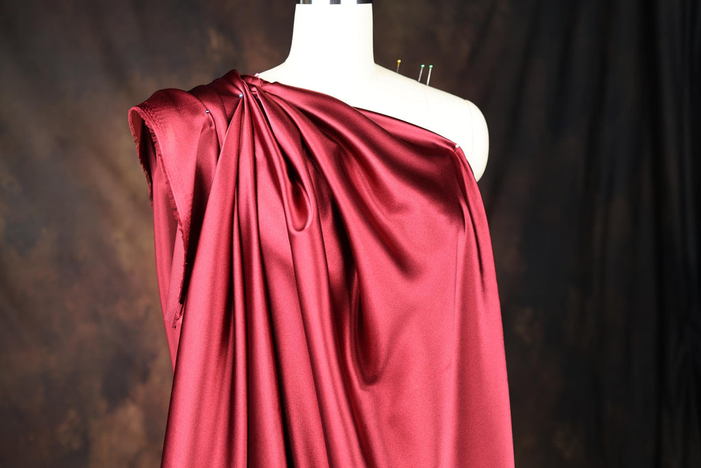 a dress on a mannequin with a red cloth draped over it