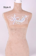 A mannequin with a decorative floral embroidered on its bust.