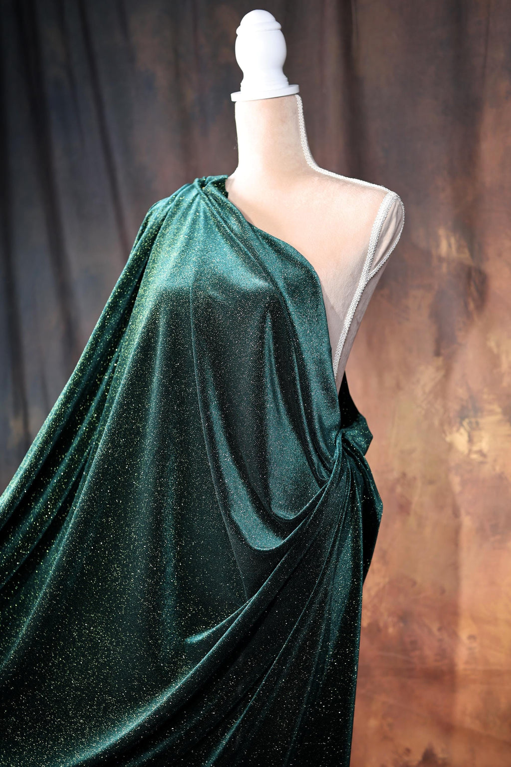 a dress on a mannequin with a green cloth draped over it