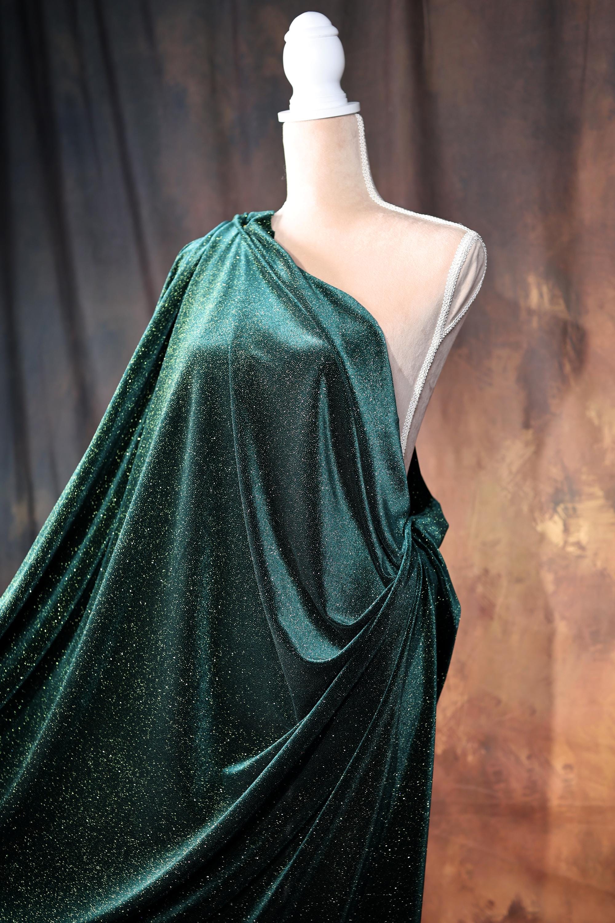 a dress on a mannequin with a green cloth draped over it
