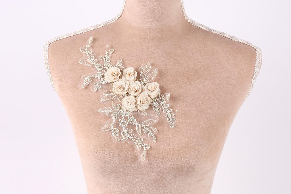 A mannequin torso with a delicate floral embroidery on the left side.