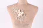 A mannequin torso with a delicate floral embroidery on the left side.