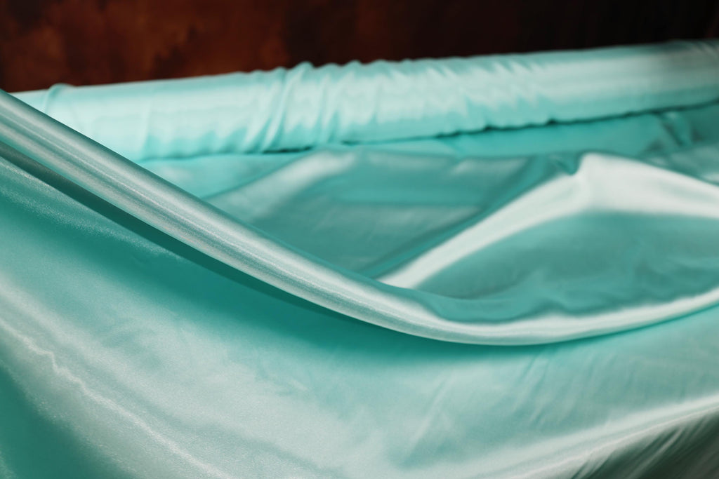 a close up of a baby crib with a blue sheet