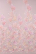 a repeating pattern of pink and yellow flowers or leaves against a pink background.