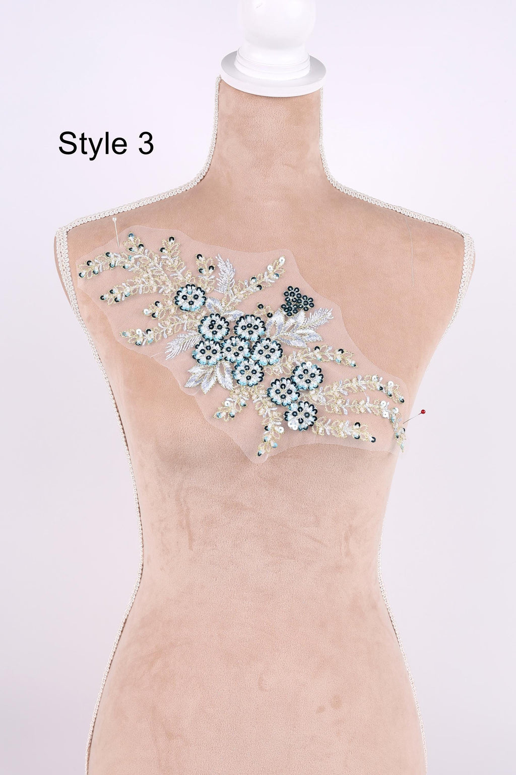A mannequin with a decorative floral embroidery on its bust.
