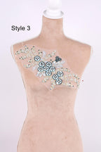 A mannequin with a decorative floral embroidery on its bust.