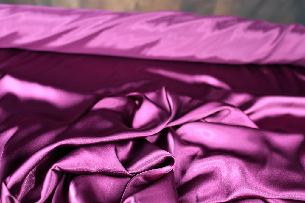 a close up of a purple satin material