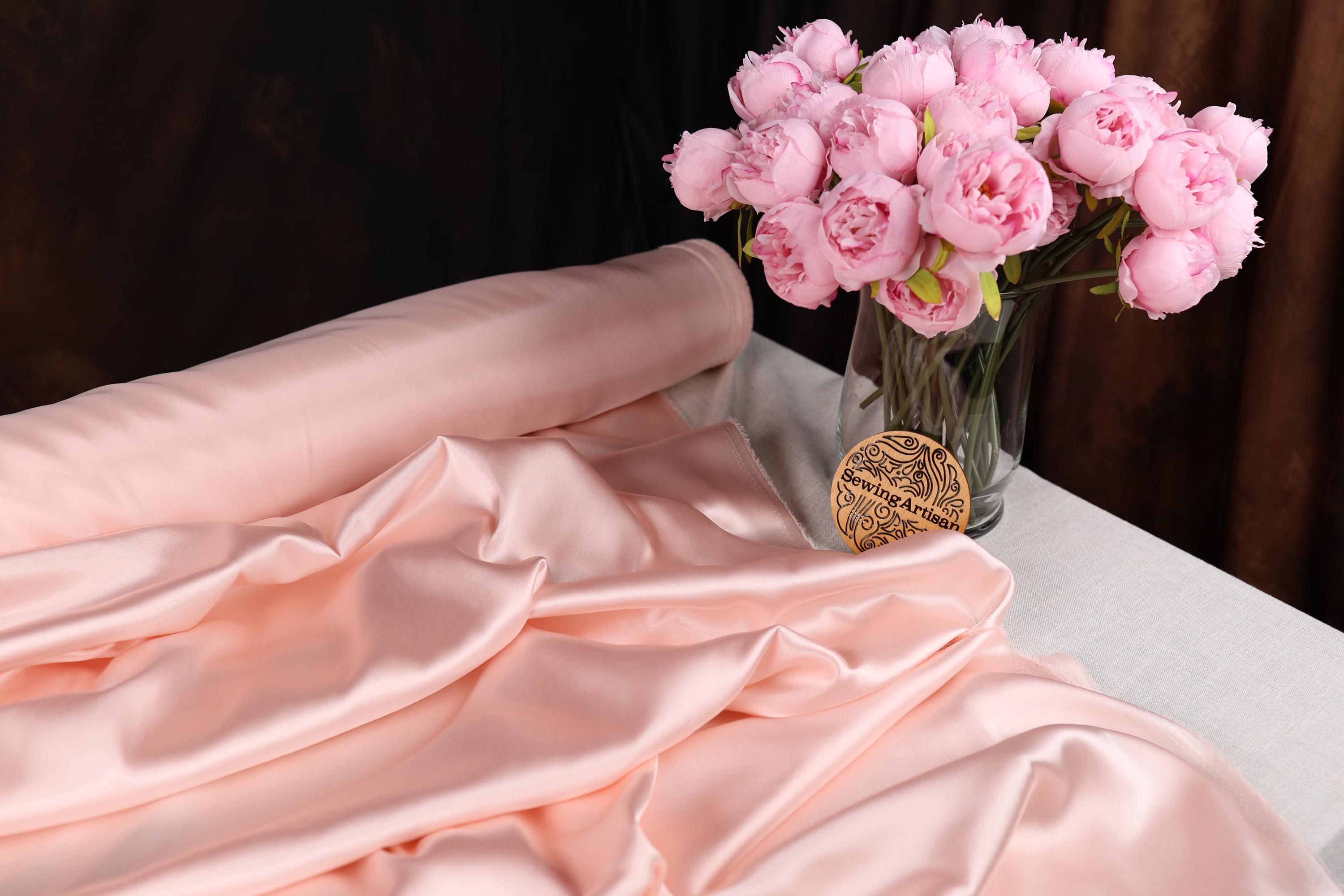 a vase filled with pink flowers on top of a table