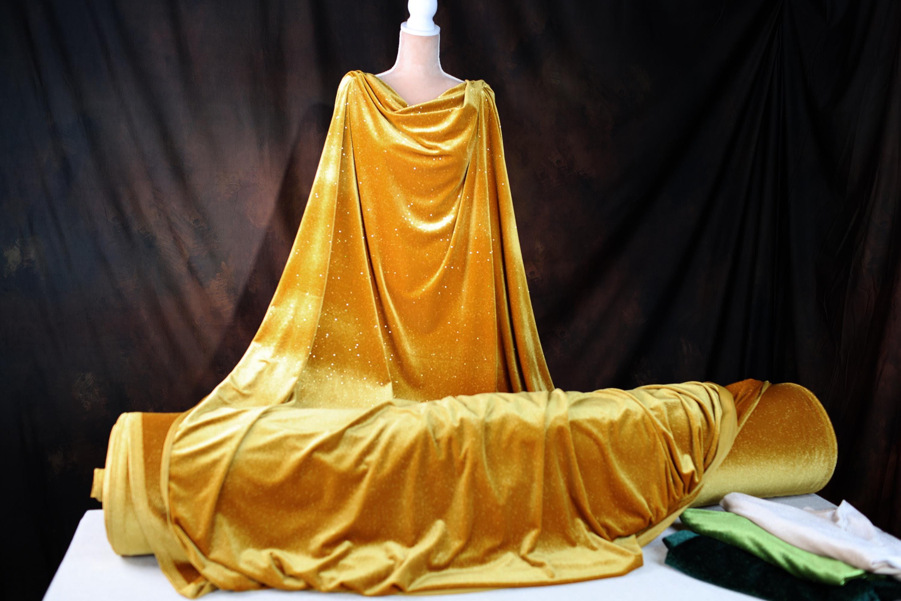 a mannequin dressed in a golden cloth
