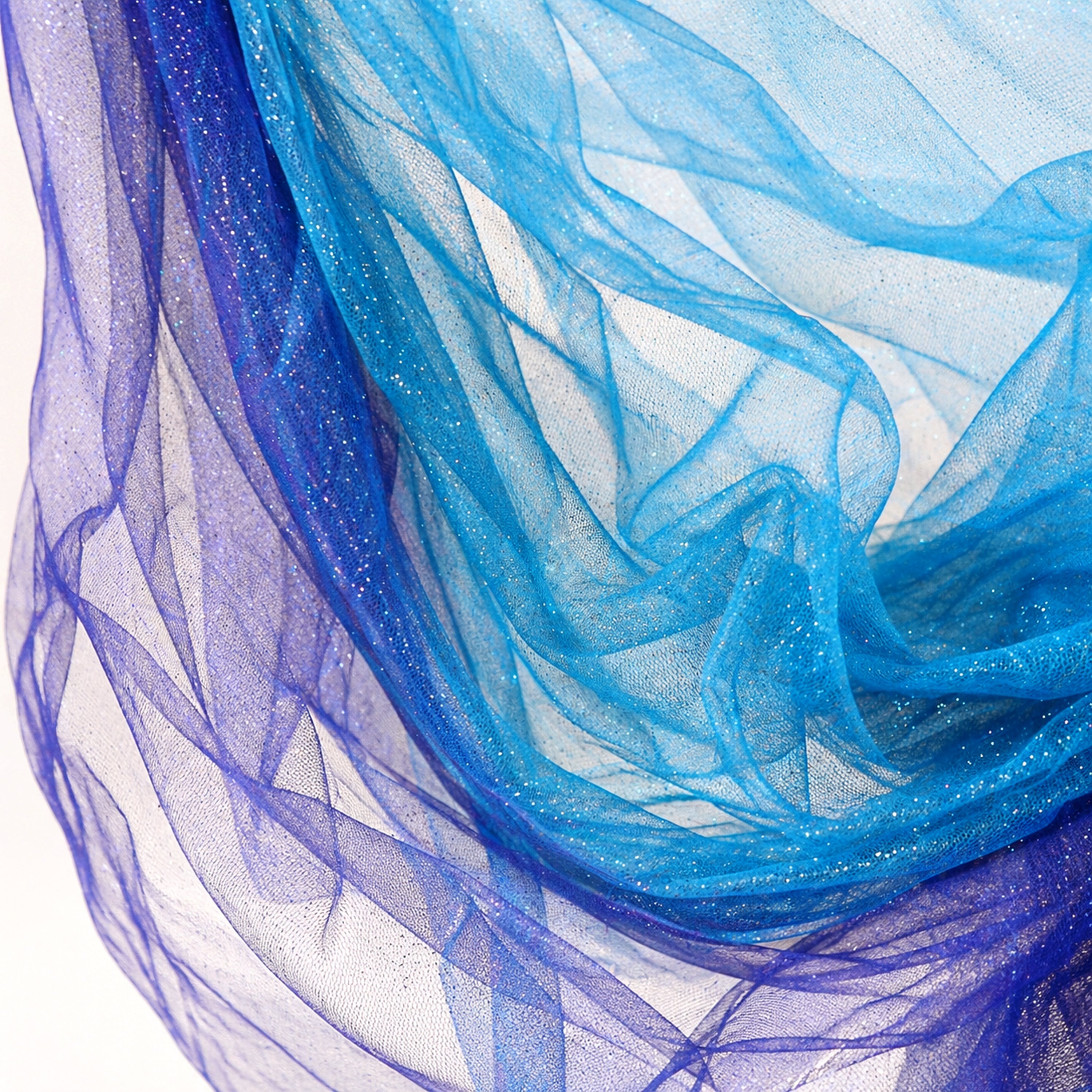 a close-up view of a piece of blue and purple fabric, with the fabric appearing to be made of sheer material. The fabric has a wavy texture, giving it a soft and flowing appearance. The colors of the fabric are vibrant and eye-catching, with the blue fabric appearing to be more dominant in the image.