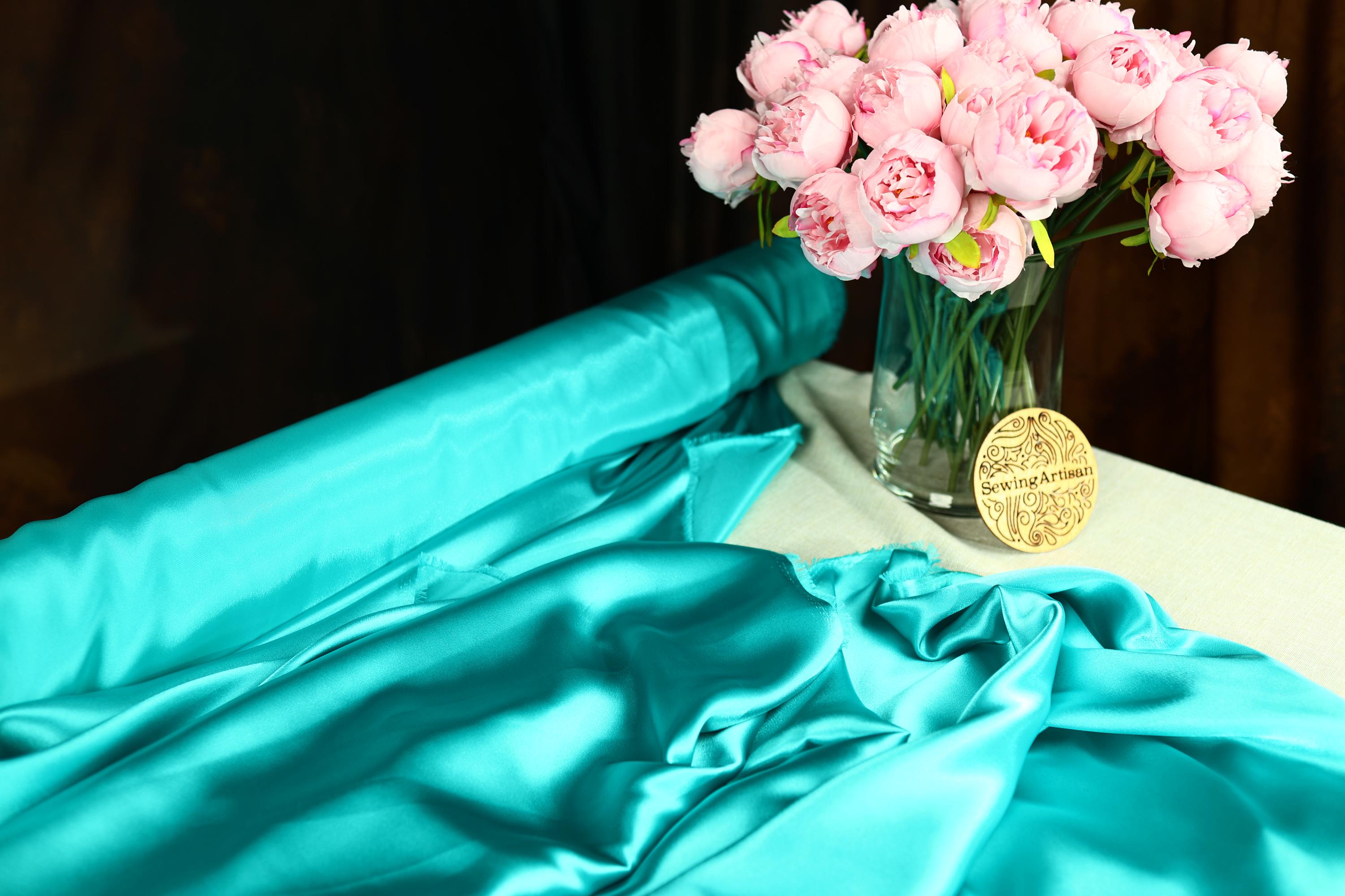 a vase filled with pink flowers on top of a table