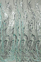 a repeating pattern of stylized leaves and branches in shades of green and black, creating a visually striking and intricate design.
