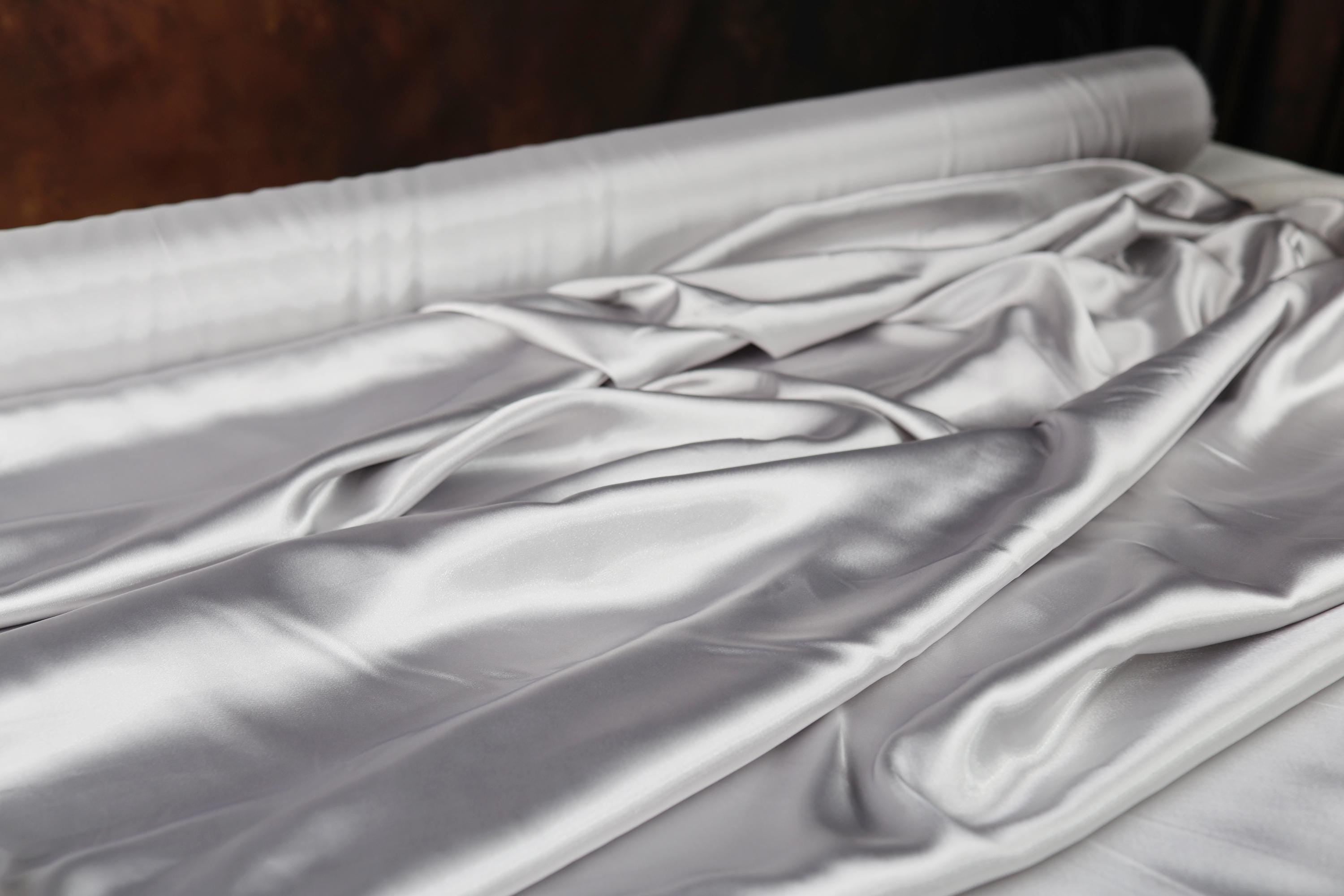 a close up of a white sheet on a bed