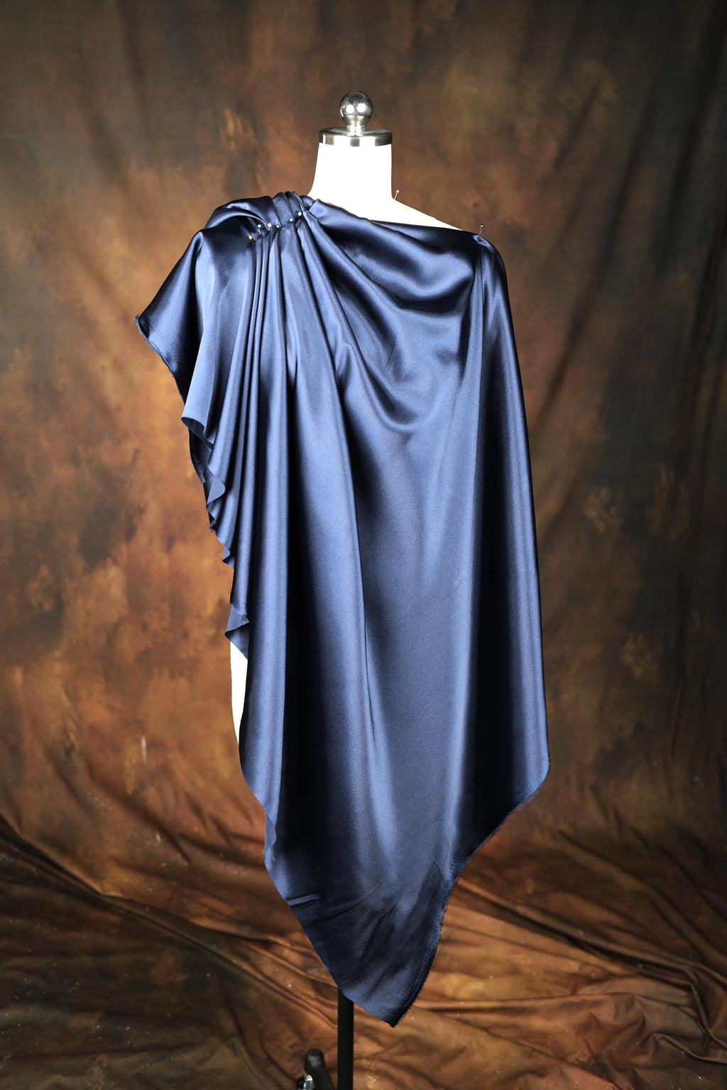 a mannequin with a blue cape on top of it