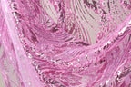 a close-up view of a fabric with a pink and purple sequined pattern. The fabric appears to be made of sheer material, with a delicate and intricate design.