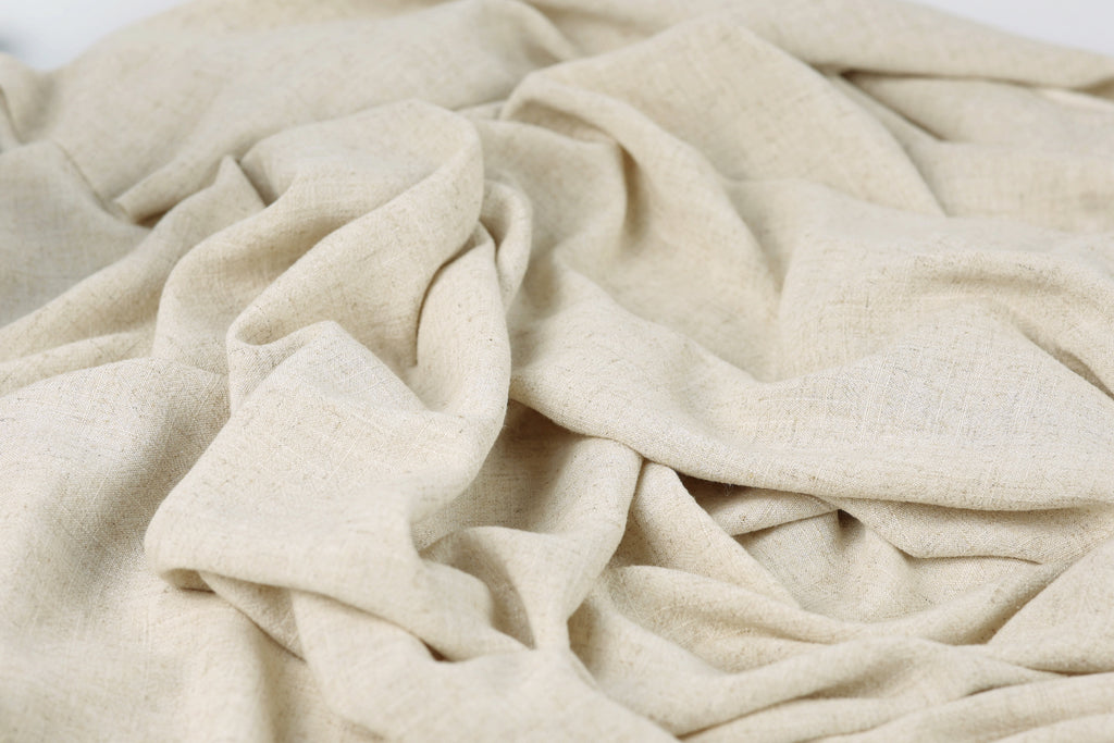 a close-up view of a crumpled, light-colored fabric, possibly a piece of linen or a similar material.