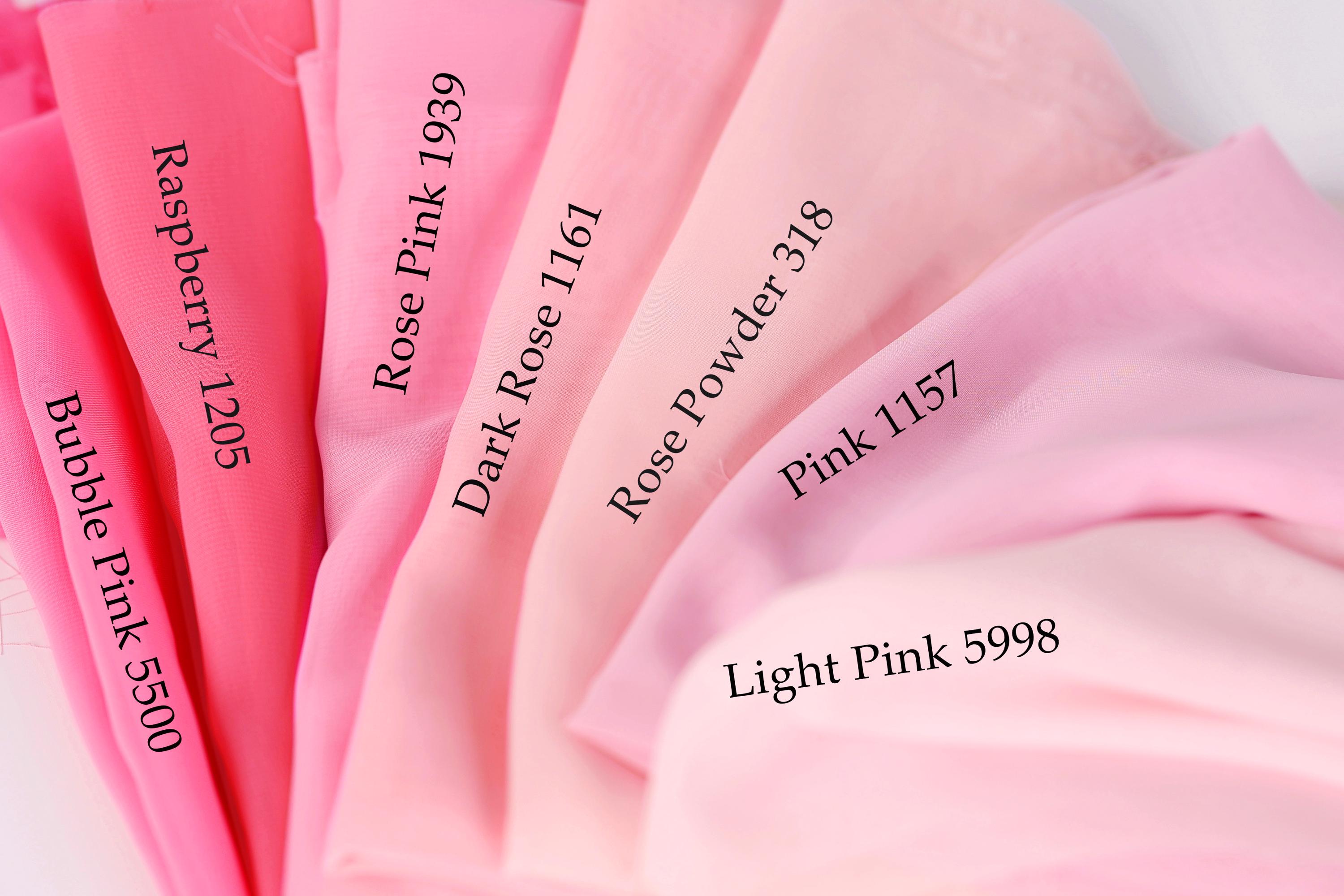 a close-up view of a collection of pink fabric swatches, each with a different shade and label indicating the color.