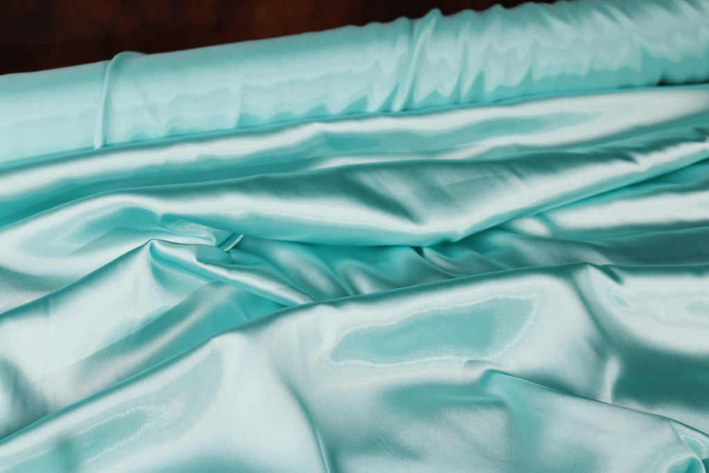 a close up of a bed with a blue comforter