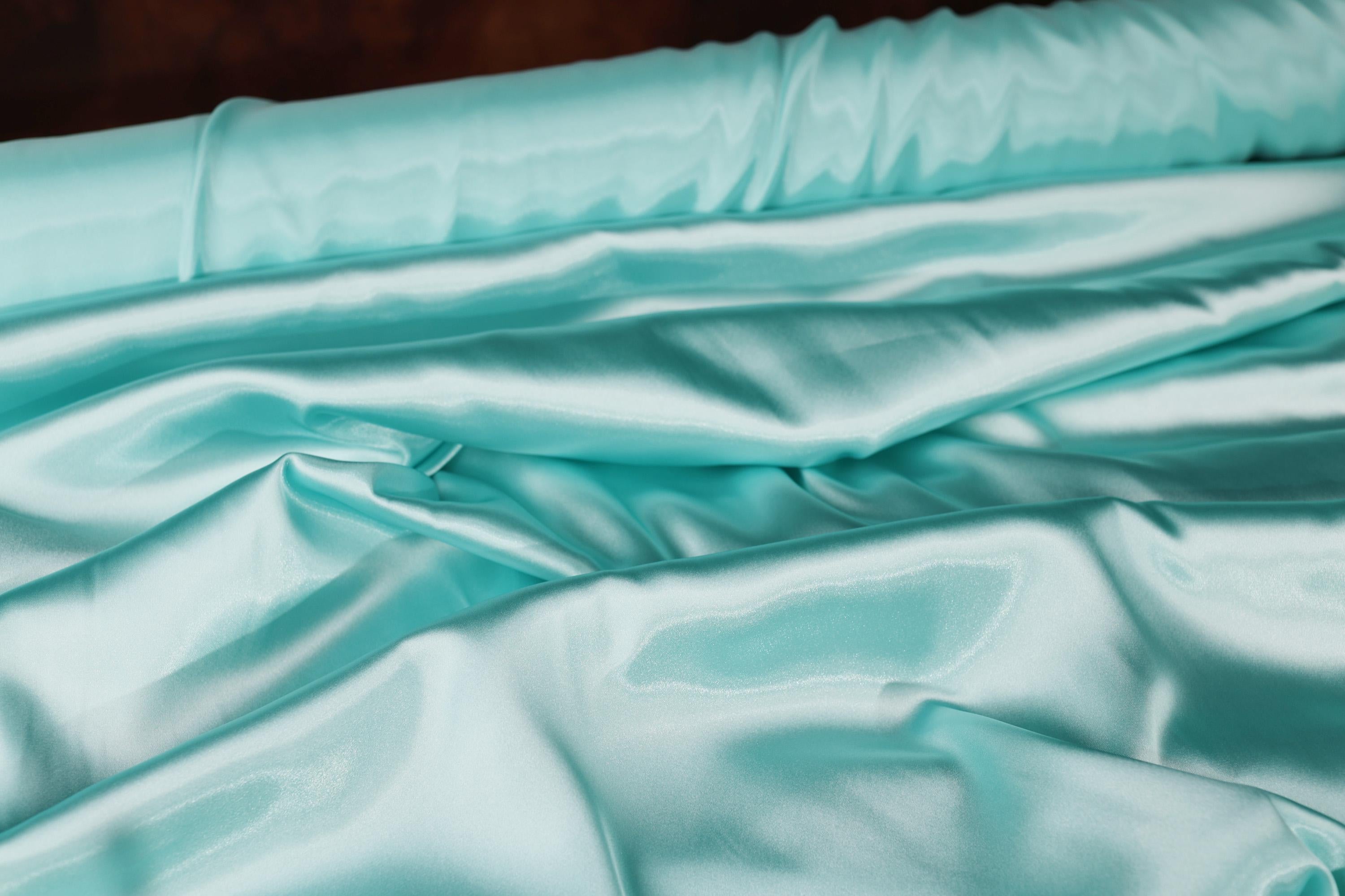 a close up of a bed with a blue comforter