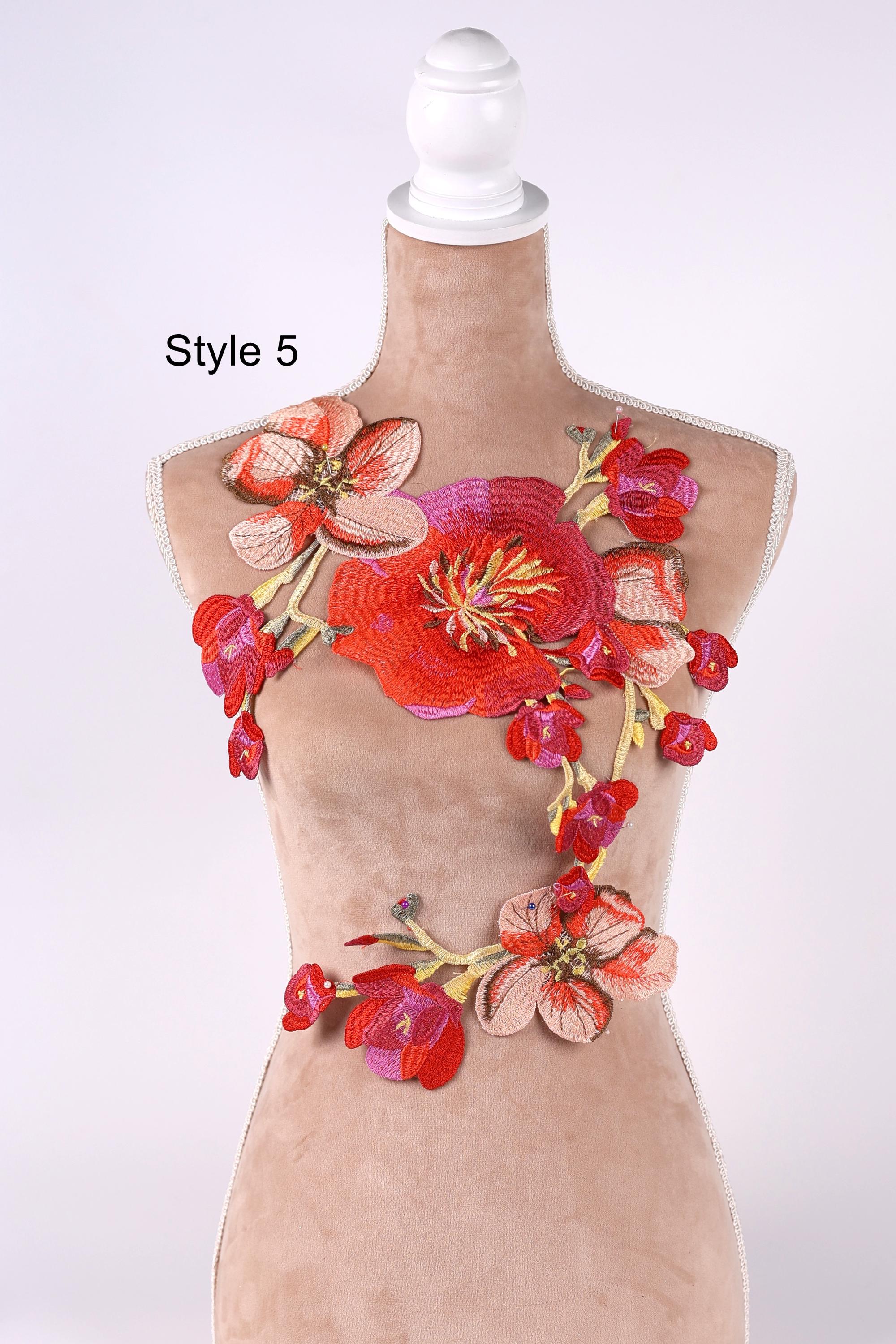 A mannequin wearing a dress with a floral embroidered design on the bust area.