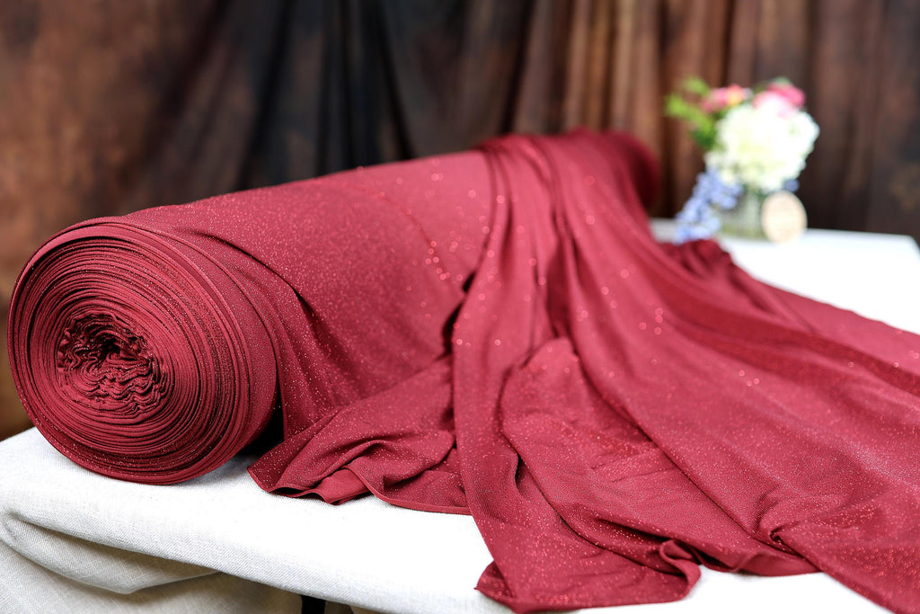 a red blanket laying on top of a white table