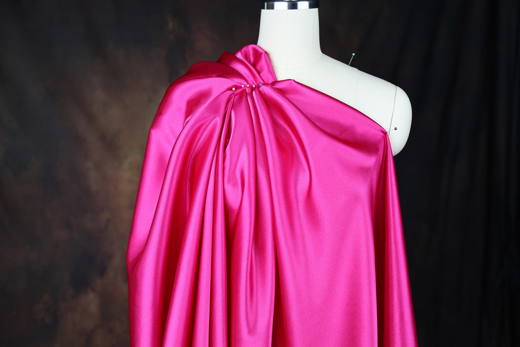 a mannequin with a pink cape on top of it
