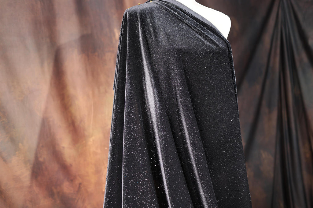 a mannequin is dressed in a black cape