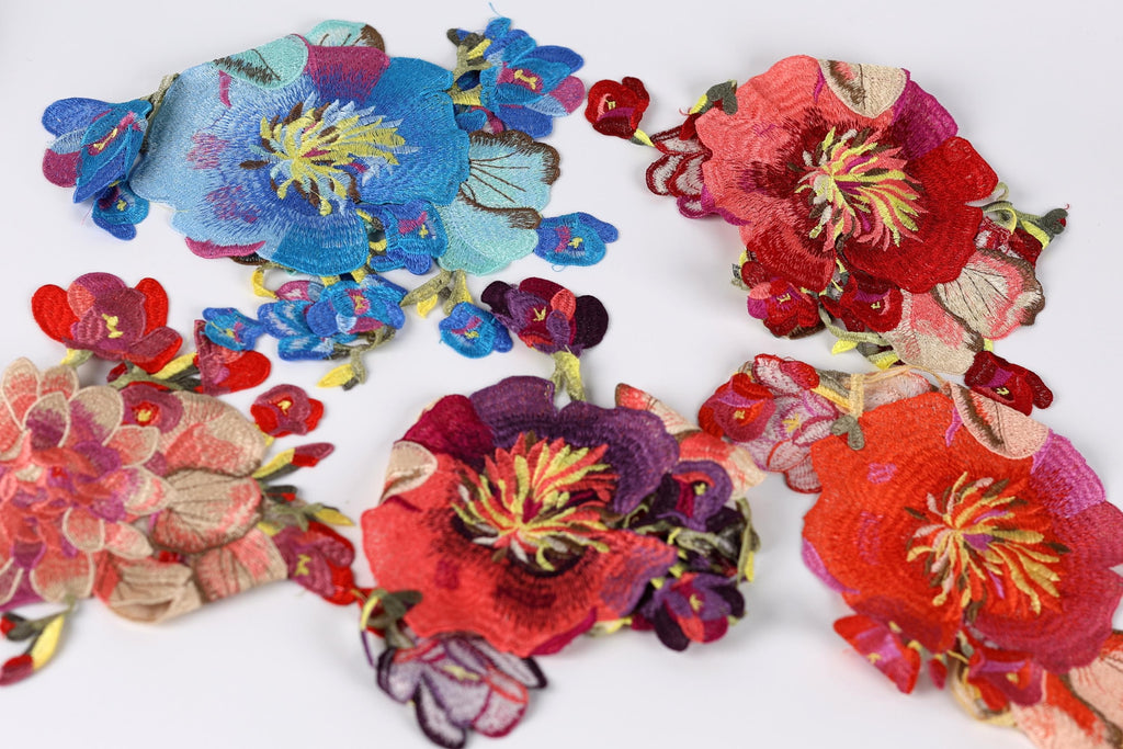 a collection of vibrant, colorful fabric pieces with intricate floral designs.