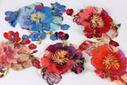 a collection of vibrant, colorful fabric pieces with intricate floral designs.