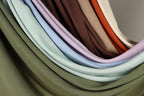 A close-up view of a collection of colorful fabric swatches, showcasing various shades and patterns.