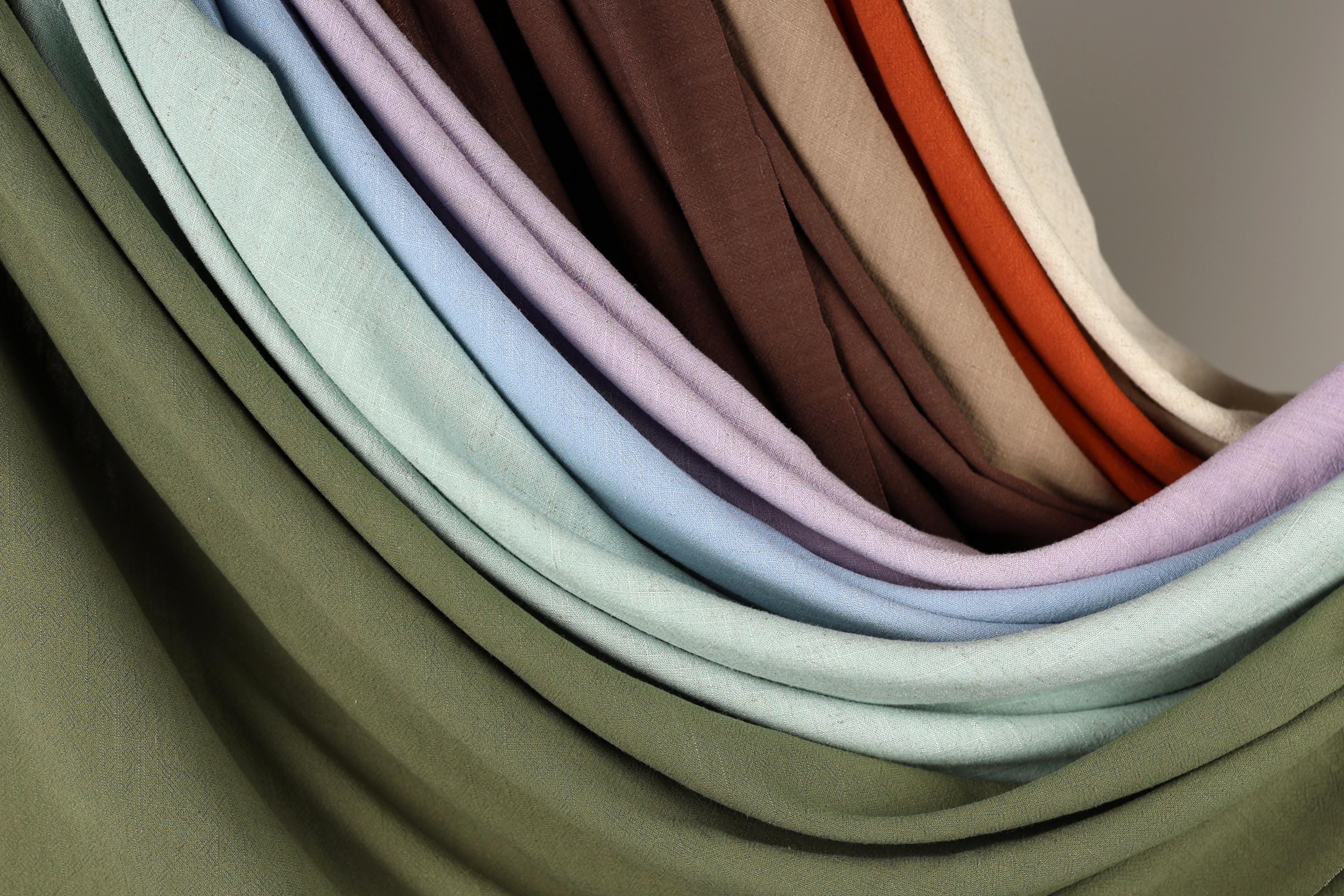 A close-up view of a collection of colorful fabric swatches, showcasing various shades and patterns.