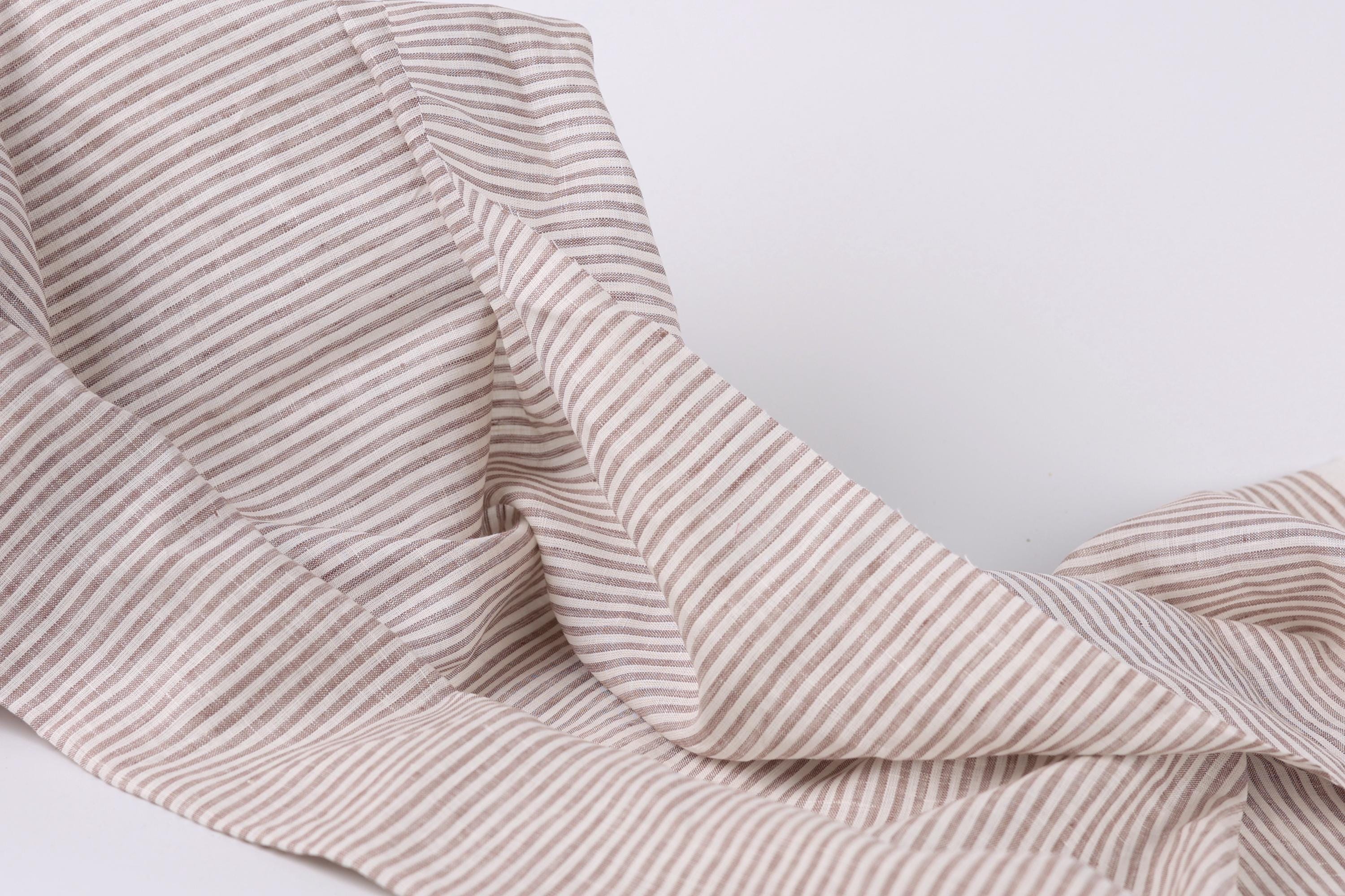 A close-up view of a fabric with horizontal stripes in various shades of brown and beige.