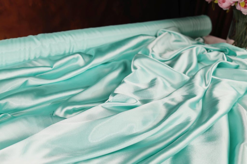 a vase of flowers sitting on top of a bed