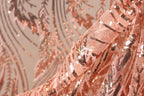 a close-up view of a fabric with a pink and black sequined pattern. The fabric appears to be made of sheer material, with the sequins arranged in a decorative and intricate manner.