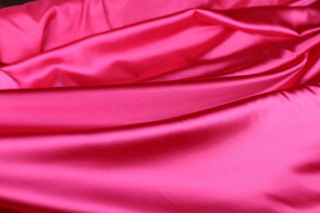 a close up of a pink satin material