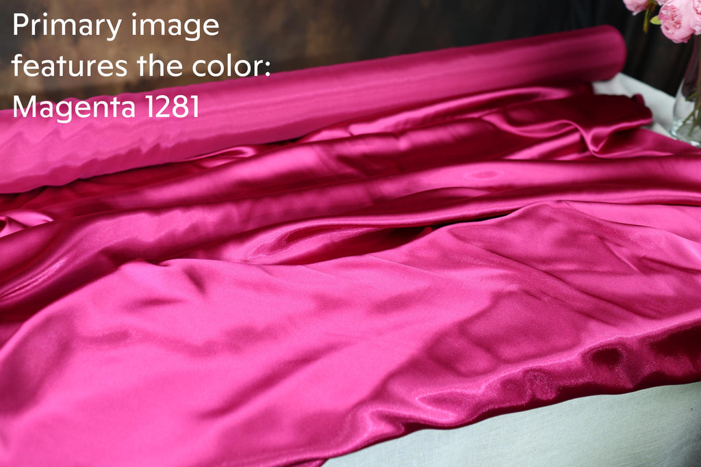 a close-up view of a vibrant pink satin fabric, with the text "Magenta 1281" visible.