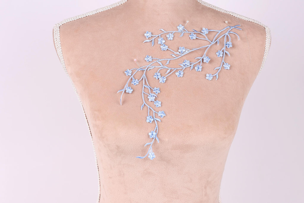 a mannequin with a delicate floral embroidery on its back.