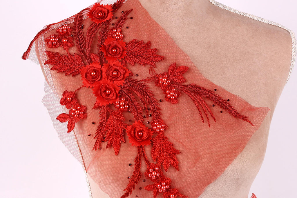 a mannequin with a red floral embroidered on its shoulder.