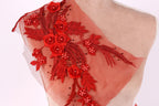a mannequin with a red floral embroidered on its shoulder.