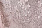 The image is a close-up of a fabric with a pink and white color scheme, featuring a pattern of sequins and beads. The fabric appears to be a sheer or sheer lace material, with a delicate and intricate design.