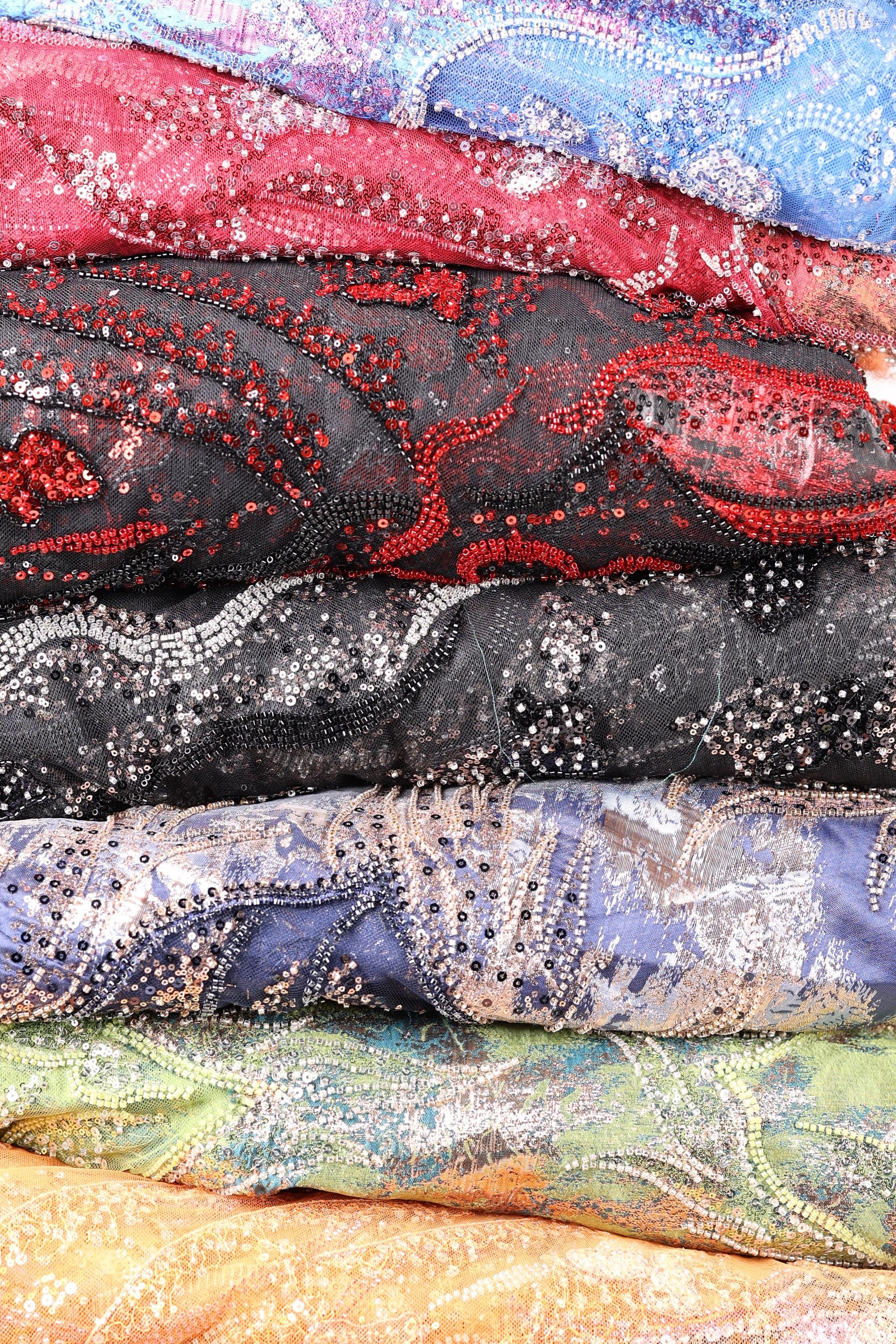 a collection of colorful, patterned fabric rolls or swatches, each with a unique design and color scheme.