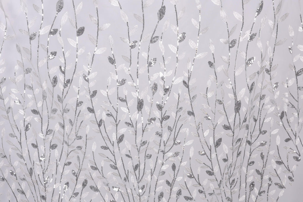 a repeating pattern of silver and white leaf-like designs on a light gray background.