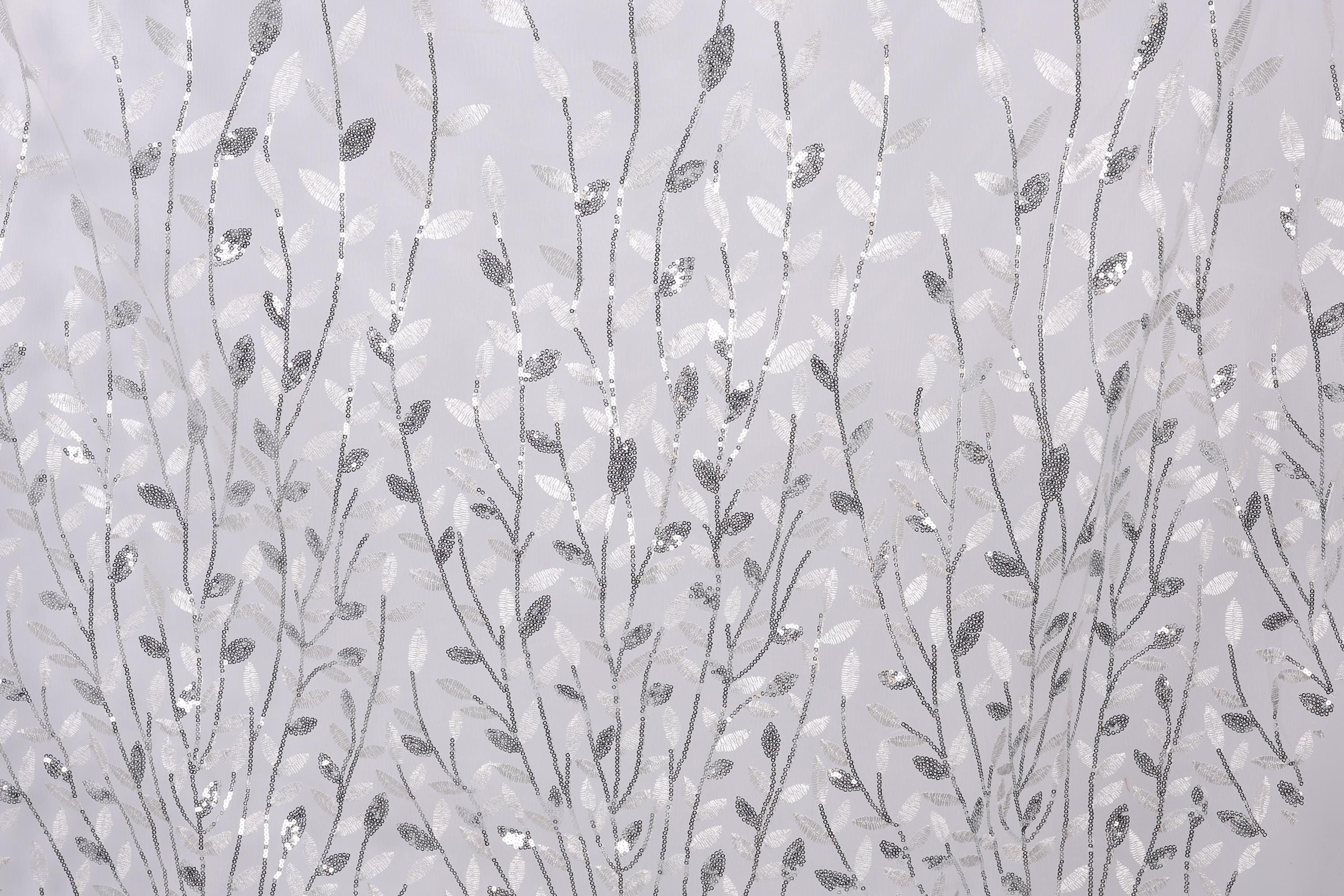 a repeating pattern of silver and white leaf-like designs on a light gray background.