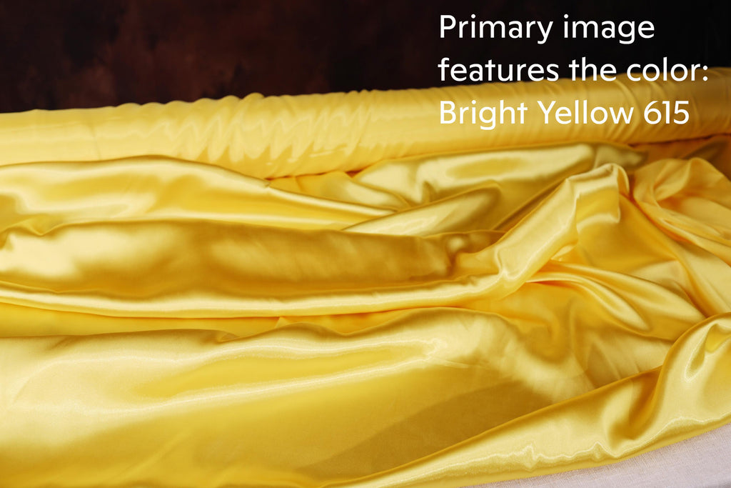 a close-up view of a yellow fabric, possibly silk or satin, with a text overlay that reads "Primary image features the color Bright Yellow 615".