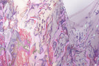 a close-up view of a fabric with a vibrant, multicolored pattern of sequins and threads, creating a visually striking and intricate design.